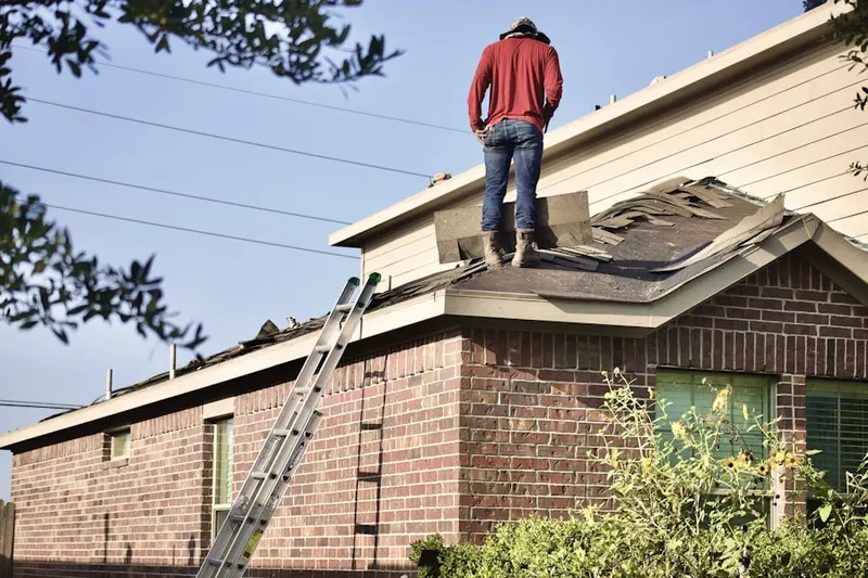 Professional roofer working on a residential roof in Voyager Village West